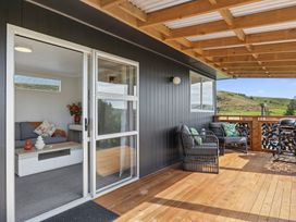 An outdoor seating area with a sofa and coffee table at Limesprings Cottage - Milton