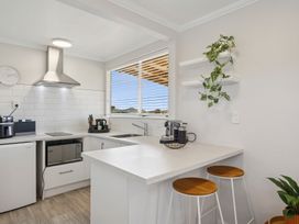 A kitchen with appliances and a sink at Limesprings Cottage - Milton