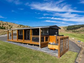 A cottage with a deck and hot tub at Limesprings Cottage - Milton Holiday Home Milton