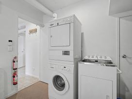 A laundry room with washing machine and dryer at Waterfront Bliss - Tairua Holiday Home, Tairua