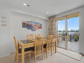 A dining room with a table and chairs at Waterfront Bliss - Tairua Holiday Home