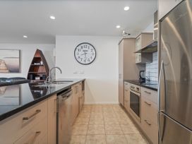 A kitchen with sink and appliances at Waterfront Bliss - Tairua Holiday Home Tairua