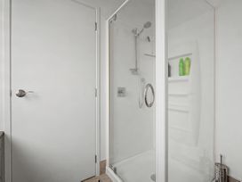 A bathroom with a shower enclosure at Waterfront Bliss - Tairua Holiday Home Tairua