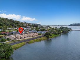 A view of houses along the water at Waterfront Bliss - Tairua Holiday Home Tairua