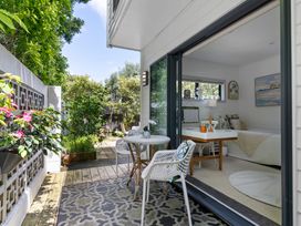 An outdoor area with a table and chairs at The Bridge Bird Sanctuary - Auckland