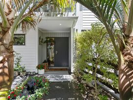 An entrance with a door and flower bed at The Bridge Bird Sanctuary - Auckland
