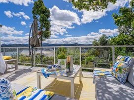 An outdoor living area with furniture and a view at Panoramic Views on Paku - Tairua Family Retreat Tairua
