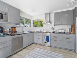 A kitchen with countertop and appliances at Panoramic Views on Paku - Tairua Family Retreat in Tairua