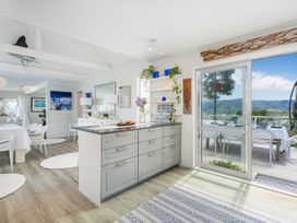 A kitchen with cabinets and countertop at Panoramic Views on Paku - Tairua