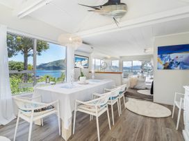 A dining room with a table and chairs at Panoramic Views on Paku - Tairua