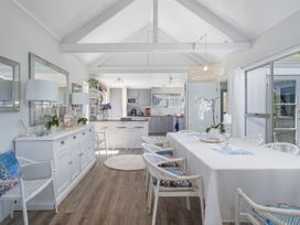 A dining room with chairs and a table at Panoramic Views on Paku - Tairua Family Retreat Tairua