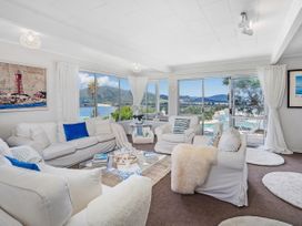 A living room with a view and light furnishings at Panoramic Views on Paku - Tairua