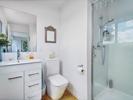 A bathroom with a shower and sink at Panoramic Views on Paku - Tairua Family Retreat