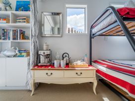 A bedroom with a bunk bed and coffee making area at Panoramic Views on Paku - Tairua