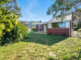 A house with garden and trees at Maison Pierre Rouge - Duvauchelle Holiday Home Akaroa