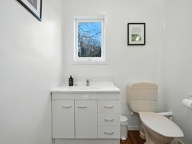A bathroom with a sink and toilet at Maison Pierre Rouge - Duvauchelle Holiday Home, Akaroa