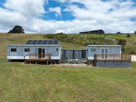 A house with solar panels and outdoor seating at Coopers Beach