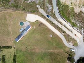 An outdoor view of a property with solar panels and a water tank at Coopers Beach
