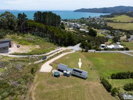 An outdoor view of a house and water tanks at Coopers Beach