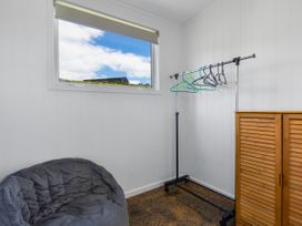 A storage area with a clothes rack and a bean bag chair at Coopers Beach