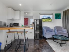 A kitchen with a microwave and refrigerator at Coopers Beach