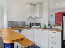 A kitchen with a microwave and stove at Coopers Beach