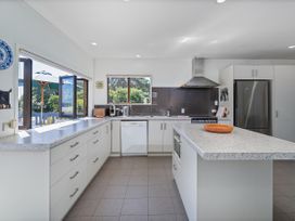 A kitchen with cabinets and appliances at Whangapoua in Whangapoua
