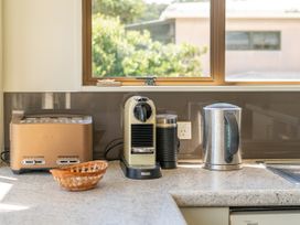 A kitchen with appliances on the countertop at Whangapoua