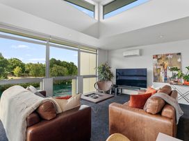 A living room with a sofa and a television at Lake Taupo Holiday Home in Taupo