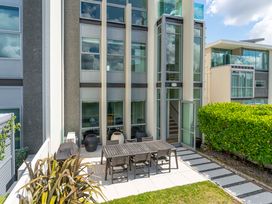 An outdoor area with a table and chairs at Lake Taupo Holiday Home Taupo