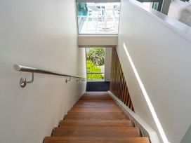 A staircase with a handrail and window at Lake Taupo Holiday Home in Taupo