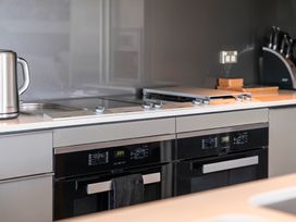 A kitchen with modern appliances at Lake Taupo Holiday Home in Taupo