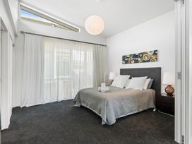 A bedroom with a bed and bedside tables at Lake Taupo Holiday Home in Taupo
