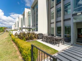 An outdoor patio area with a table and chairs at Lake Taupo Holiday Home in Taupo
