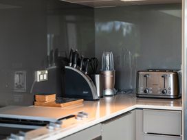 A kitchen with appliances and utensils at Lake Taupo Holiday Home in Taupo