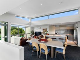 A living room with a dining area and kitchen at Lake Taupo Holiday Home in Taupo
