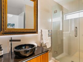 A bathroom with a sink and shower at Lake Taupo Holiday Home in Taupo