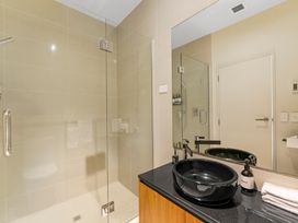 A bathroom with a sink and shower at Lake Taupo Holiday Home in Taupo
