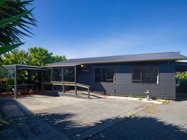 A house with a patio and garden at The Bach - Kaikoura Holiday Home Kaikoura