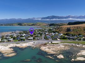 An aerial view of a coastal area with houses and mountains at The Bach - Kaikoura Holiday Home Kaikoura