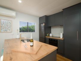 A kitchen with a countertop and appliances at The Bach - Kaikoura Holiday Home in Kaikoura