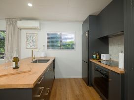 A kitchen with a countertop and appliances at The Bach - Kaikoura Holiday Home Kaikoura
