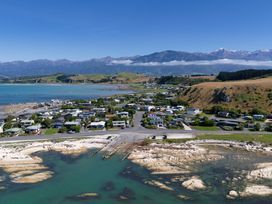 A coastal view with houses and mountains at The Bach - Kaikoura Holiday Home in Kaikoura