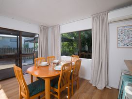 A dining room with a table and chairs at The Bach - Kaikoura Holiday Home, Kaikoura