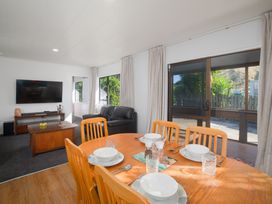 A dining room with a table set for a meal at The Bach - Kaikoura Holiday Home in Kaikoura