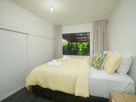 A bedroom with a bed and window at The Bach - Kaikoura Holiday Home Kaikoura
