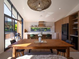 A kitchen with wooden table and chairs at Sunderland Views - Clyde Holiday Home in Clyde