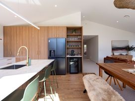 A kitchen with a refrigerator, sink, and dining table at Sunderland Views - Clyde Holiday Home Clyde