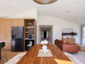A kitchen with a refrigerator and dining table at Sunderland Views - Clyde Holiday Home Clyde