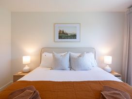 A bedroom with a bed and bedside tables at Sunderland Views - Clyde Holiday Home